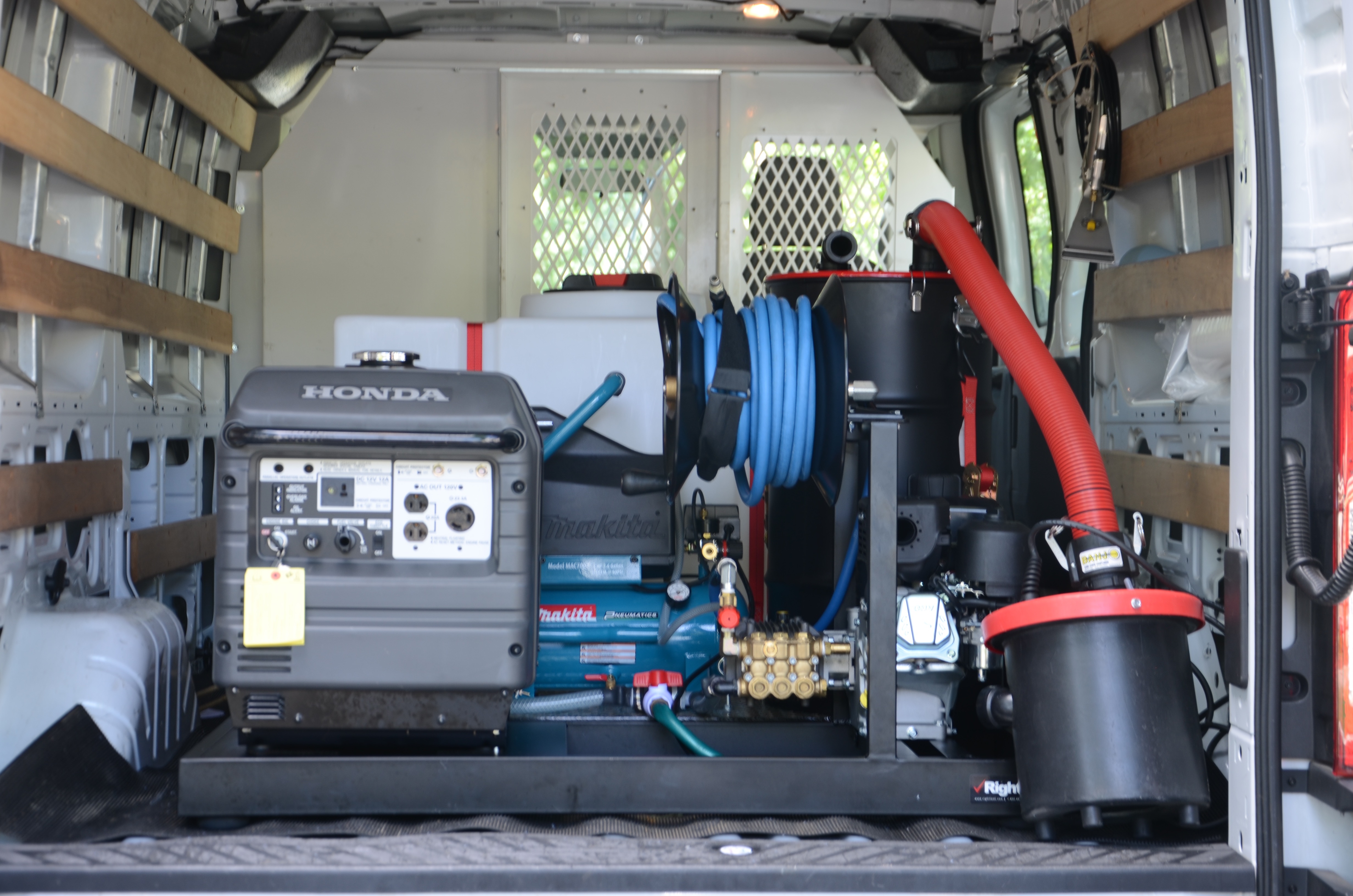 mobile car detailing equipment van including generator, power washer, water source, and vacuum
