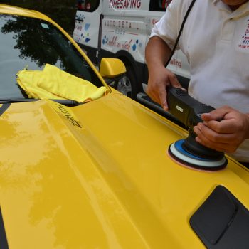Polishing the hood of a sports car during mobile auto detailing by Time Saving Auto Detail